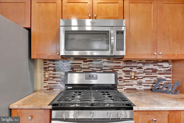 26 Millbank Ln, Voorhees, NJ 08043 - kitchen with appliances with stainless steel finishes, decorative backsplash, and light stone countertops