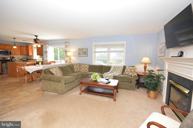 321 Coventry Ln, Lititz, PA 17543 - living room with a glass covered fireplace, ceiling fan, and light carpet