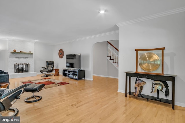 220 Longview Blvd, Gettysburg, PA 17325 - living area with crown molding, stairway, wood finished floors, arched walkways, and a fireplace