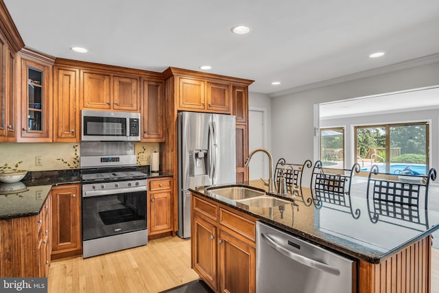 220 Longview Blvd, Gettysburg, PA 17325 - kitchen featuring stainless steel appliances, dark stone countertops, light wood-style floors, recessed lighting, and an island with sink