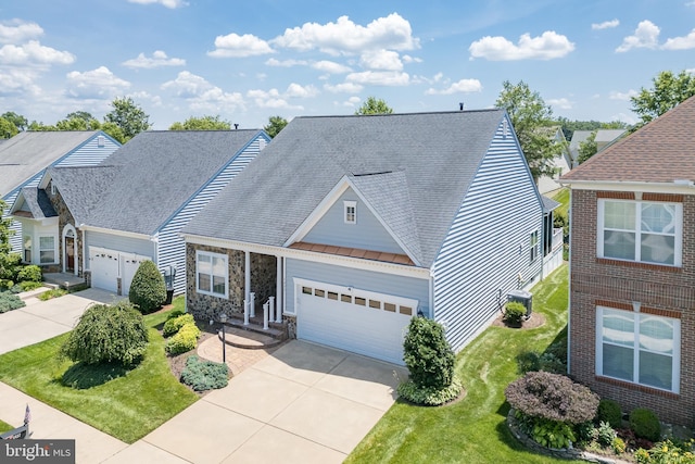 6037 Calumet Ct, Gainesville, VA 20155 - traditional home with driveway, a standing seam roof, an attached garage, a metal roof, and stone siding
