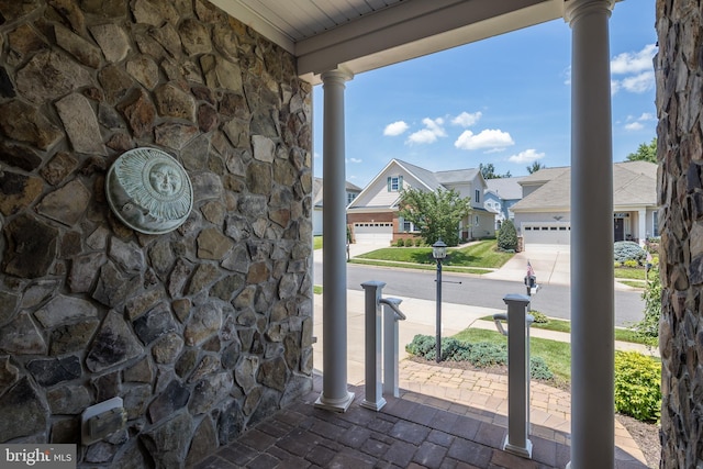 6037 Calumet Ct, Gainesville, VA 20155 - covered porch with concrete driveway, a residential view, and a garage