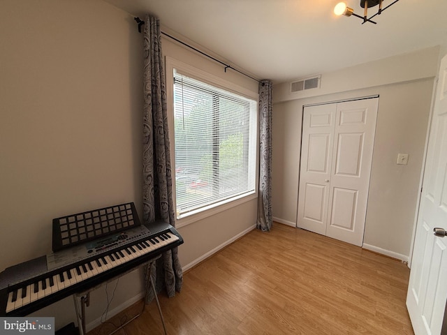 9711 Kings Crown Ct Unit 101, Fairfax, VA 22031 - bedroom with light wood-type flooring, a chandelier, and a closet