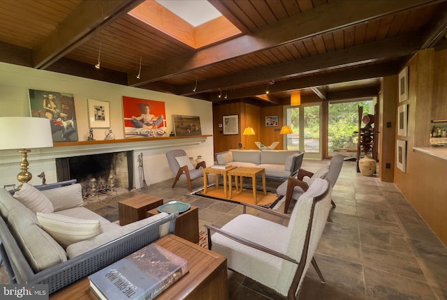 617 Old Mill Rd, Gettysburg, PA 17325 - living room with a wooden ceiling with exposed beams, a fireplace with flush hearth, a skylight, stone finish flooring, and wood walls