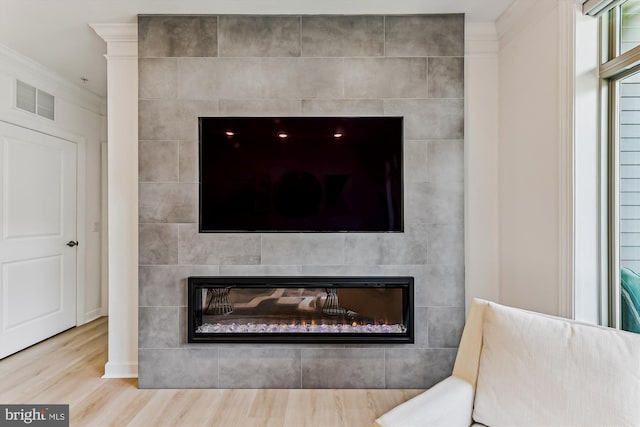 6107 Fairview Farm Dr Unit 306, Alexandria, VA 22315 - detailed view of a glass covered fireplace, wood finished floors, and ornamental molding