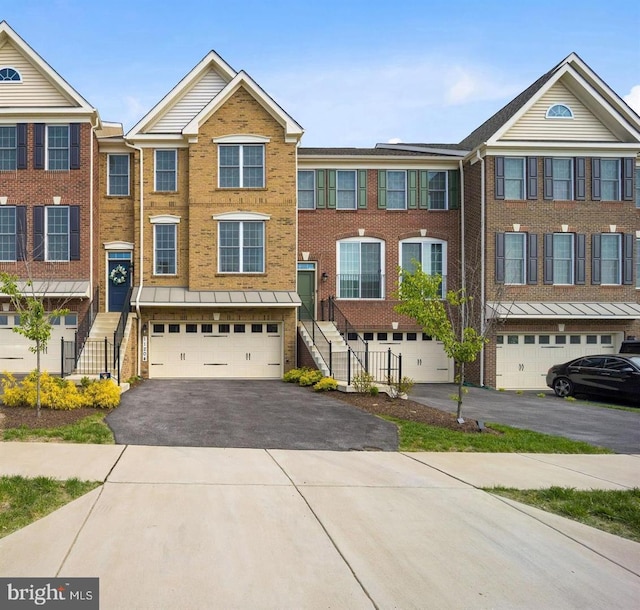 11204 Side Saddle Dr, Upper Marlboro, MD 20772 - townhome / multi-family property with a garage, driveway, brick siding, and stairway