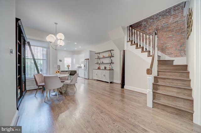 1842 N Capitol St NW, Washington, DC 20002 - dining room with stairs, light wood-style floors, a chandelier, brick wall, and recessed lighting
