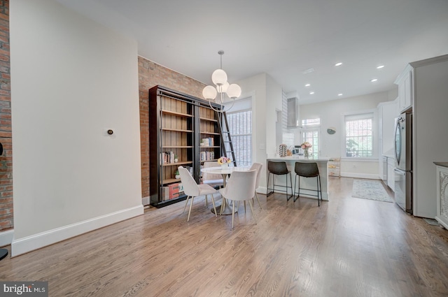 1842 N Capitol St NW, Washington, DC 20002 - dining area featuring light wood-style flooring, a chandelier, recessed lighting, and brick wall