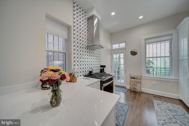 1842 N Capitol St NW, Washington, DC 20002 - kitchen featuring wall chimney exhaust hood, gas stove, healthy amount of natural light, wood finished floors, and recessed lighting