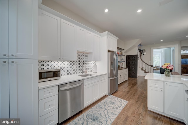 1842 N Capitol St NW, Washington, DC 20002 - kitchen featuring stainless steel appliances, white cabinetry, light countertops, tasteful backsplash, and recessed lighting