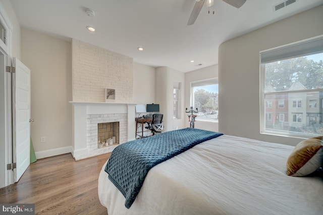 1842 N Capitol St NW, Washington, DC 20002 - bedroom with wood finished floors, a brick fireplace, recessed lighting, and ceiling fan