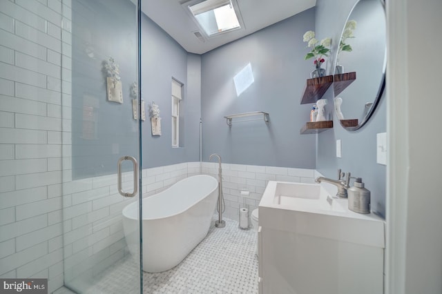 1842 N Capitol St NW, Washington, DC 20002 - full bath featuring tile walls, a freestanding bath, vanity, a stall shower, and a wainscoted wall