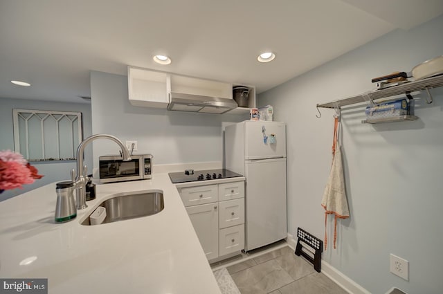 1842 N Capitol St NW, Washington, DC 20002 - kitchen featuring freestanding refrigerator, exhaust hood, black electric cooktop, light countertops, and white cabinetry