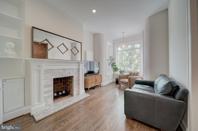 1842 N Capitol St NW, Washington, DC 20002 - living area featuring wood finished floors, a fireplace with raised hearth, and recessed lighting