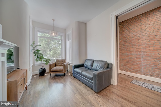 1842 N Capitol St NW, Washington, DC 20002 - living area with wood finished floors and brick wall