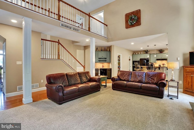 404 Herington Dr, Reading, PA 19608 - carpeted living area featuring ornate columns, a high ceiling, stairway, and recessed lighting
