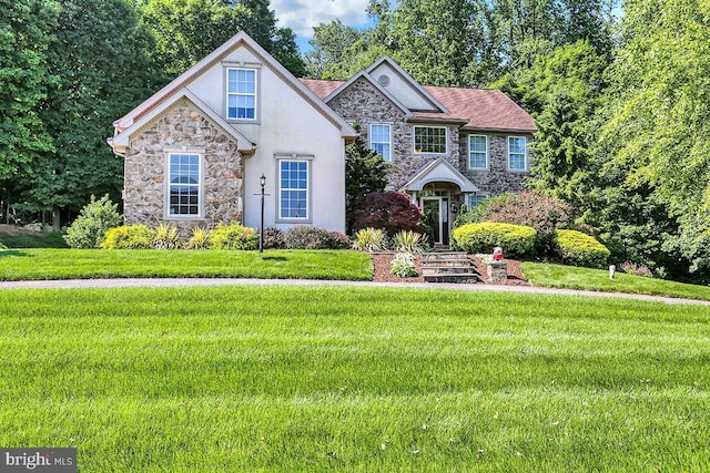 404 Herington Dr, Reading, PA 19608 - view of front facade with stone siding, stucco siding, and a front lawn