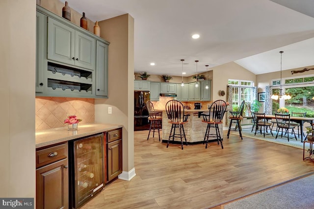404 Herington Dr, Reading, PA 19608 - kitchen with beverage cooler, a kitchen bar, freestanding refrigerator, light wood-type flooring, and recessed lighting