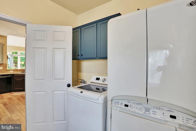404 Herington Dr, Reading, PA 19608 - washroom featuring cabinet space, washer and dryer, and light wood-style floors