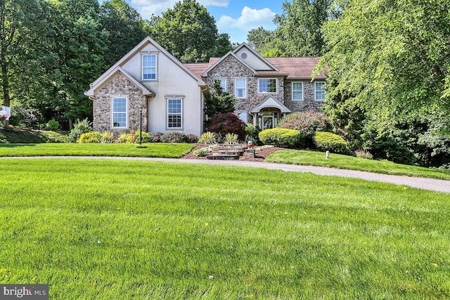 404 Herington Dr, Reading, PA 19608 - view of front of house featuring stone siding, stucco siding, and a front lawn