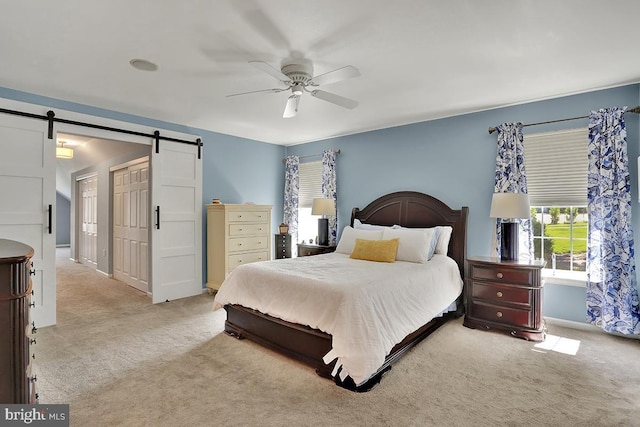 404 Herington Dr, Reading, PA 19608 - bedroom with a barn door, light colored carpet, and ceiling fan