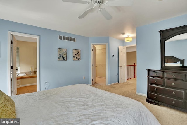 404 Herington Dr, Reading, PA 19608 - bedroom with light colored carpet, a spacious closet, ensuite bath, and a ceiling fan
