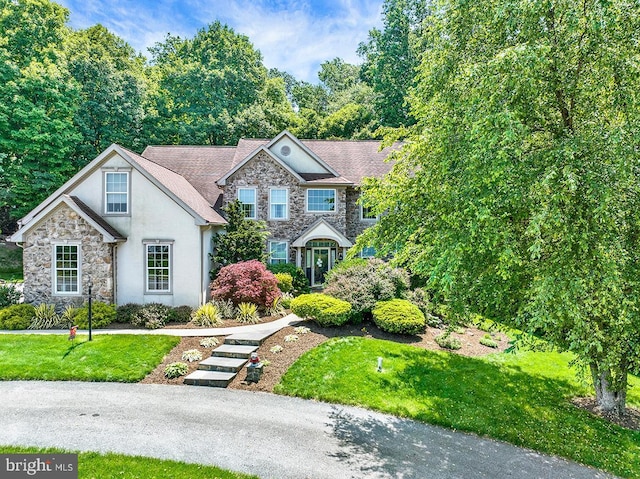 404 Herington Dr, Reading, PA 19608 - view of front of house featuring stone siding, stucco siding, and a front yard