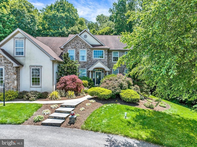 404 Herington Dr, Reading, PA 19608 - view of front of house featuring stone siding, stucco siding, and a front lawn