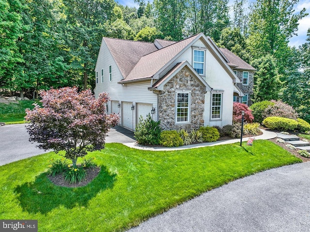 404 Herington Dr, Reading, PA 19608 - view of front facade featuring stone siding, a front lawn, asphalt driveway, and an attached garage