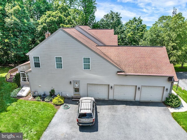 404 Herington Dr, Reading, PA 19608 - view of front of home featuring asphalt driveway, a chimney, roof with shingles, and a front yard