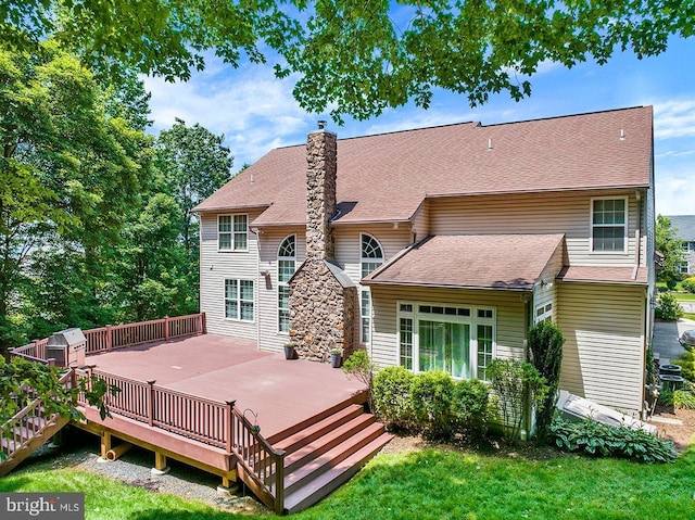 404 Herington Dr, Reading, PA 19608 - back of property featuring a deck, a chimney, a shingled roof, and a lawn
