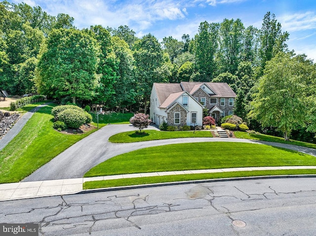 404 Herington Dr, Reading, PA 19608 - tudor-style house featuring stone siding, curved driveway, and a front yard