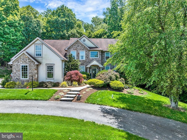 404 Herington Dr, Reading, PA 19608 - view of front facade with stone siding, a front yard, and stucco siding