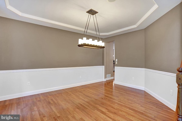 404 Herington Dr, Reading, PA 19608 - spare room featuring a raised ceiling, wood finished floors, ornamental molding, and a chandelier