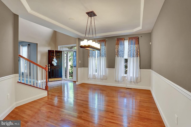 404 Herington Dr, Reading, PA 19608 - unfurnished dining area featuring a tray ceiling, wood finished floors, stairway, and a chandelier