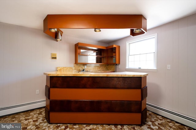 3990 View Top Rd, Ellicott City, MD 21042 - kitchen featuring a baseboard radiator, light countertops, tile patterned floors, open shelves, and wood walls