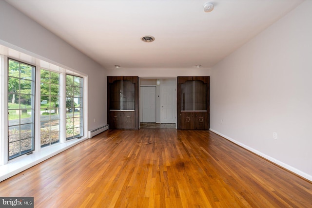 3990 View Top Rd, Ellicott City, MD 21042 - unfurnished bedroom featuring wood finished floors and a baseboard radiator