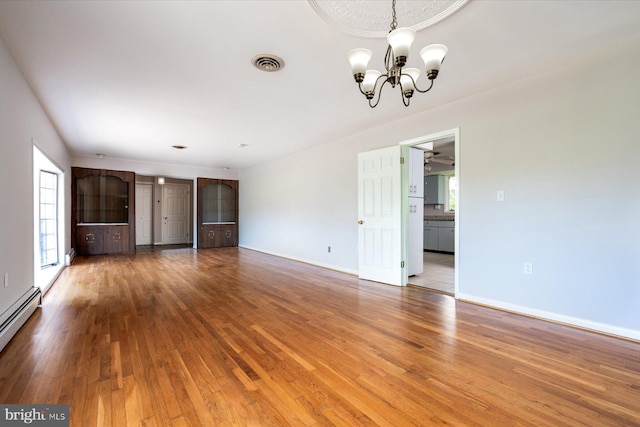 3990 View Top Rd, Ellicott City, MD 21042 - unfurnished living room featuring a chandelier, hardwood / wood-style floors, and a baseboard heating unit