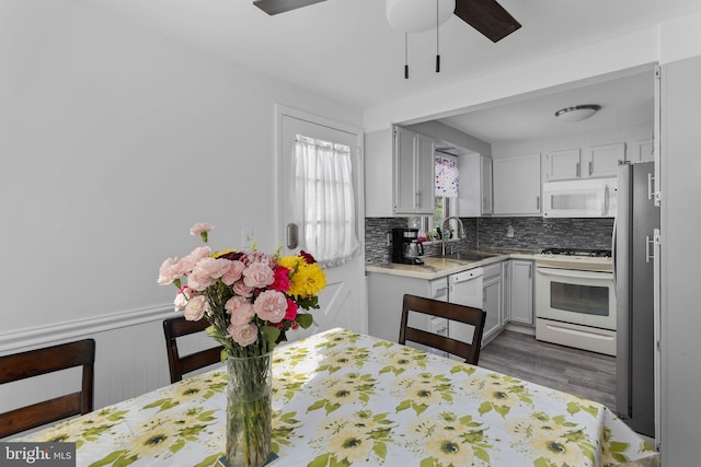 260 Irvington Pl, Hamilton, NJ 08610 - kitchen with white appliances, light countertops, a ceiling fan, wood finished floors, and tasteful backsplash