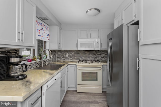 260 Irvington Pl, Hamilton, NJ 08610 - kitchen with white appliances, light wood finished floors, tasteful backsplash, and white cabinetry