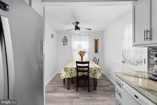 260 Irvington Pl, Hamilton, NJ 08610 - dining space featuring wood finished floors, ceiling fan, and a wainscoted wall