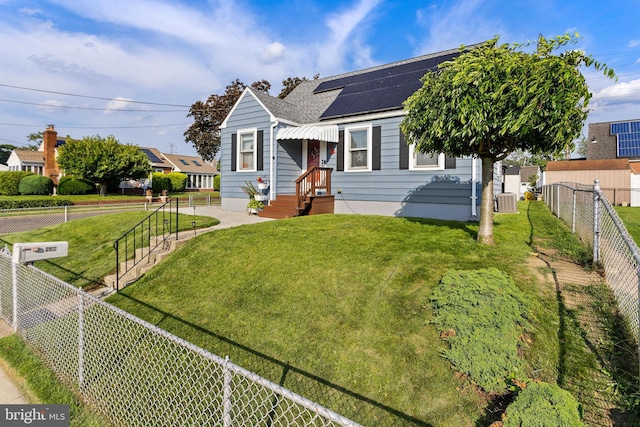 260 Irvington Pl, Hamilton, NJ 08610 - view of front of house featuring a shingled roof, a fenced backyard, and solar panels