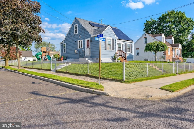 260 Irvington Pl, Hamilton, NJ 08610 - bungalow-style home featuring a fenced front yard, entry steps, roof mounted solar panels, and roof with shingles