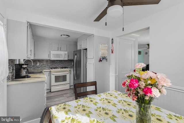 260 Irvington Pl, Hamilton, NJ 08610 - kitchen with white appliances, ceiling fan, light countertops, and light wood-type flooring
