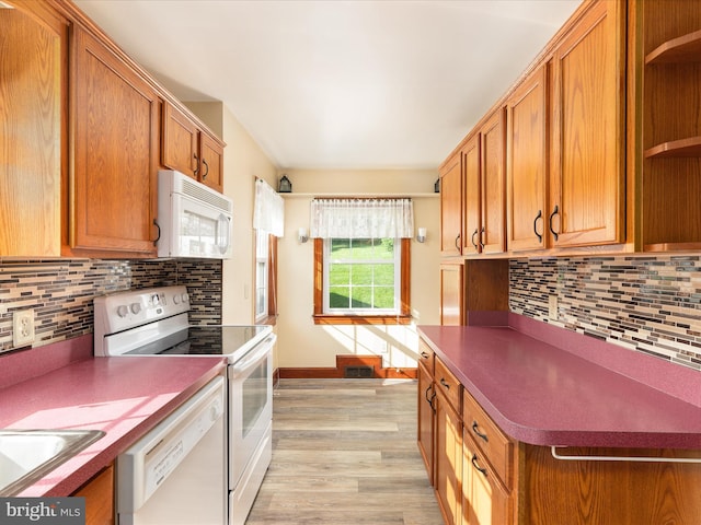 55 W Duck St, Front Royal, VA 22630 - kitchen with white appliances, open shelves, tasteful backsplash, light wood-style floors, and brown cabinets