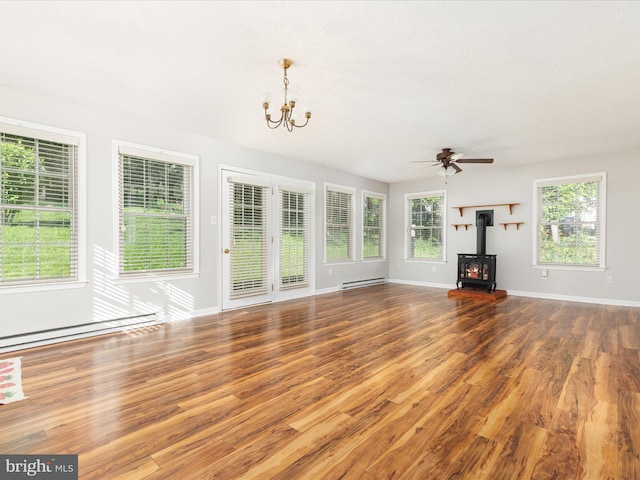 55 W Duck St, Front Royal, VA 22630 - unfurnished living room featuring a baseboard radiator, a wood stove, a chandelier, and wood finished floors