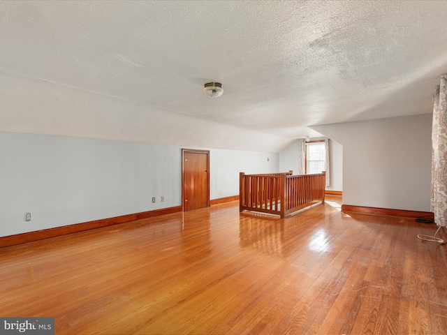 55 W Duck St, Front Royal, VA 22630 - bonus room with vaulted ceiling, light wood-style floors, and a textured ceiling