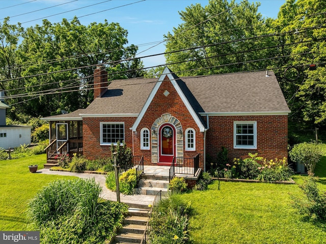 55 W Duck St, Front Royal, VA 22630 - tudor home with brick siding, a chimney, a front lawn, and a shingled roof