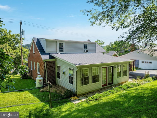 55 W Duck St, Front Royal, VA 22630 - rear view of house with roof with shingles, a lawn, a garage, and brick siding