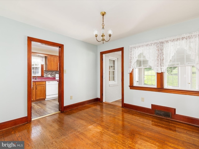 55 W Duck St, Front Royal, VA 22630 - empty room with a chandelier and wood finished floors